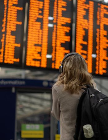 Woman looking at train departure board