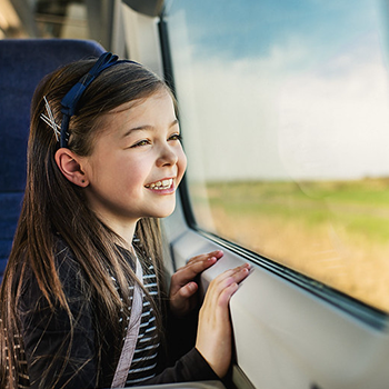 Child smiling and looking out the window