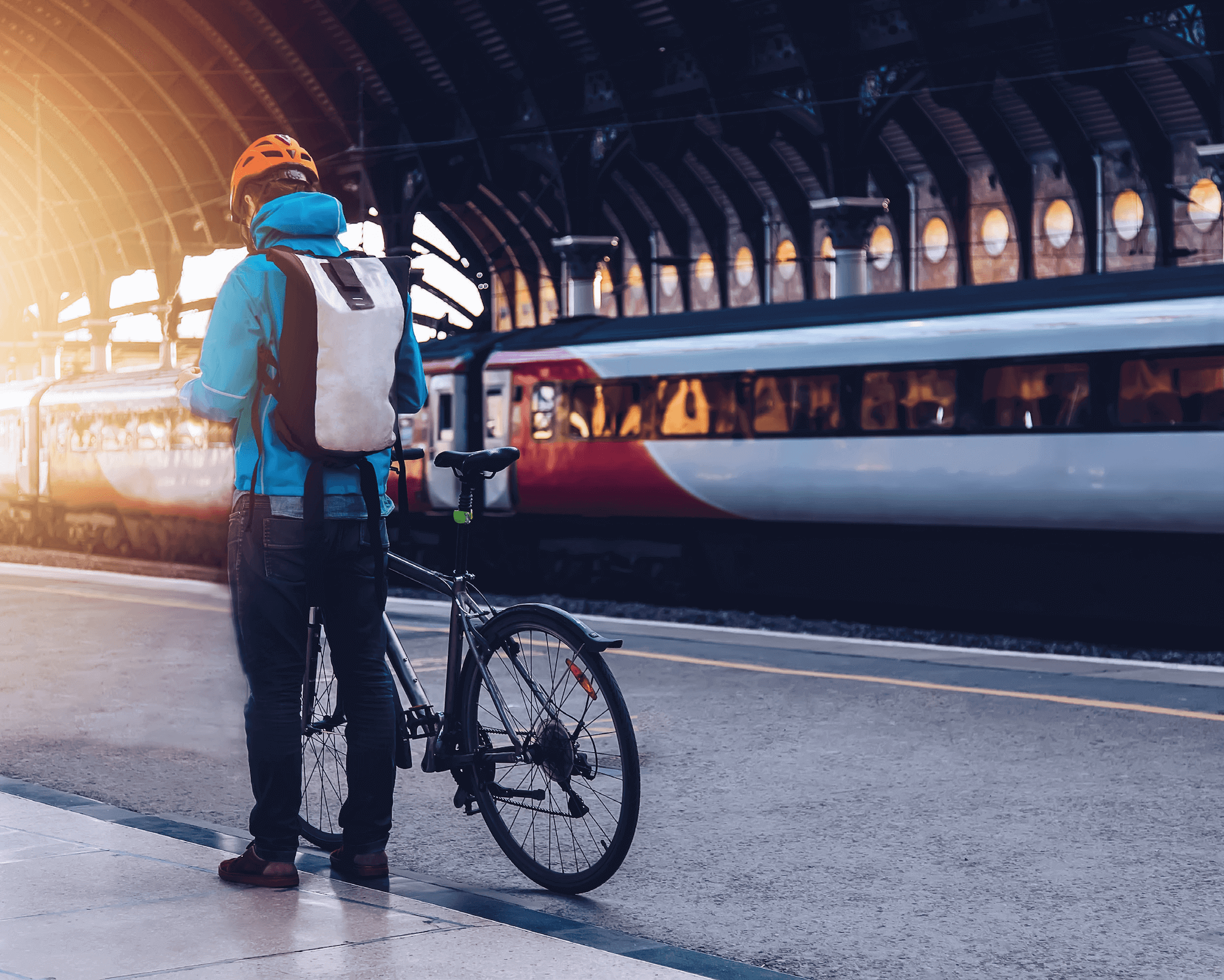 Rail passenger with a bicycle at a train station